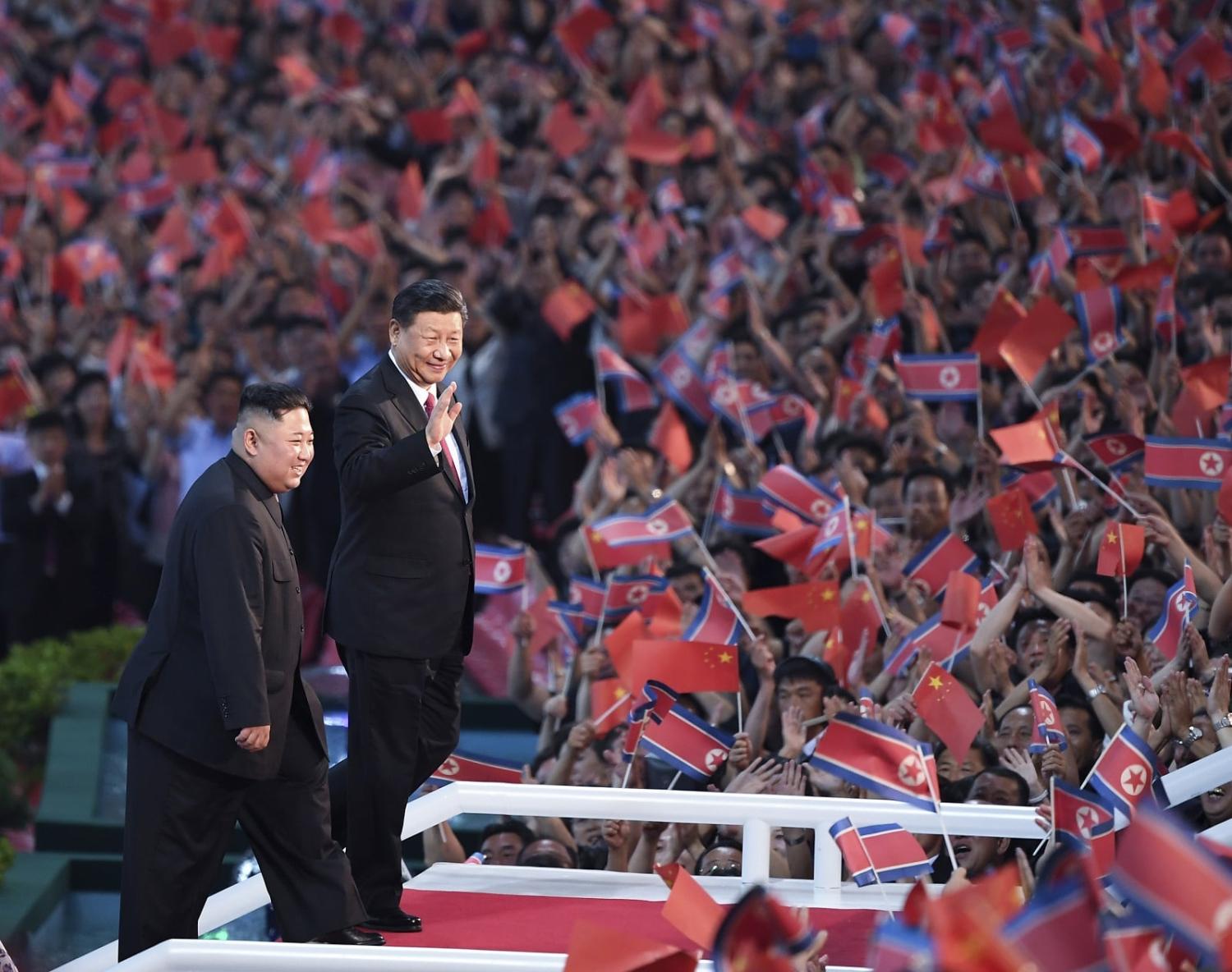 North Korean leader Kim Jong-un (L) and Chinese President Xi Jinping (R) watch a performance at the May Day Stadium in Pyongyang on 20 June 2019 (Yan Yan/Xinhua via Getty Images)